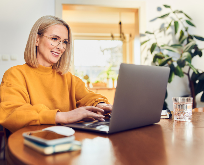Person At Home Looking At Laptop